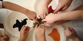 children joint hands in a play activity