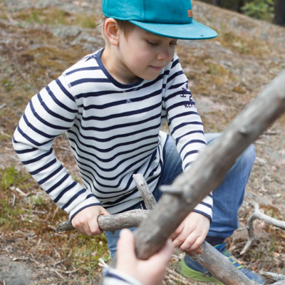 Boy building in the woods 400 x 400