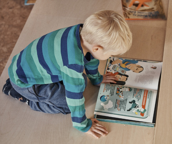 Boy reading book 600 x 500