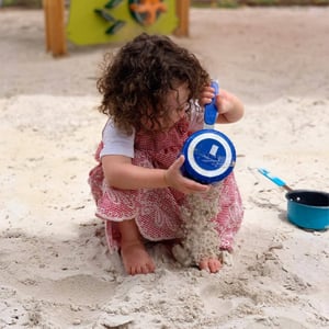 Girl playing with sand 400 x 400